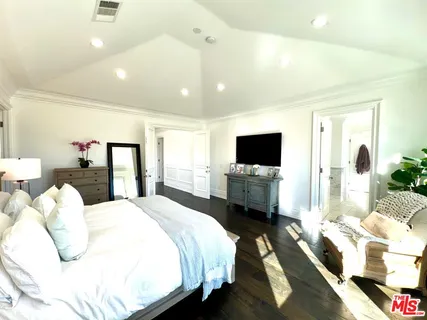 a bedroom with a bed and tv