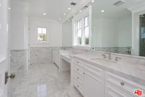 a bathroom with a granite countertop sink mirror and double