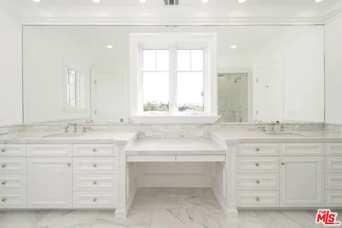 a bathroom with a granite countertop sink mirror and a