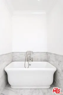 a white bath tub sitting in a bathroom