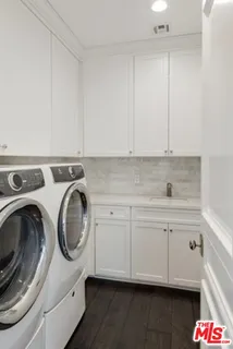 a utility room with sink dryer and washer