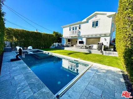 a view of a house with swimming pool and sitting area
