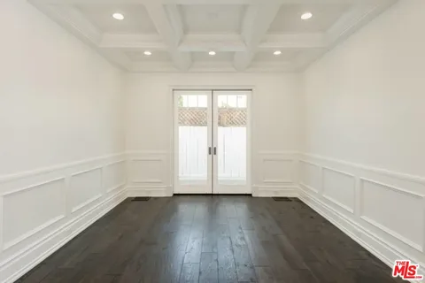 an empty room with wooden floor and window