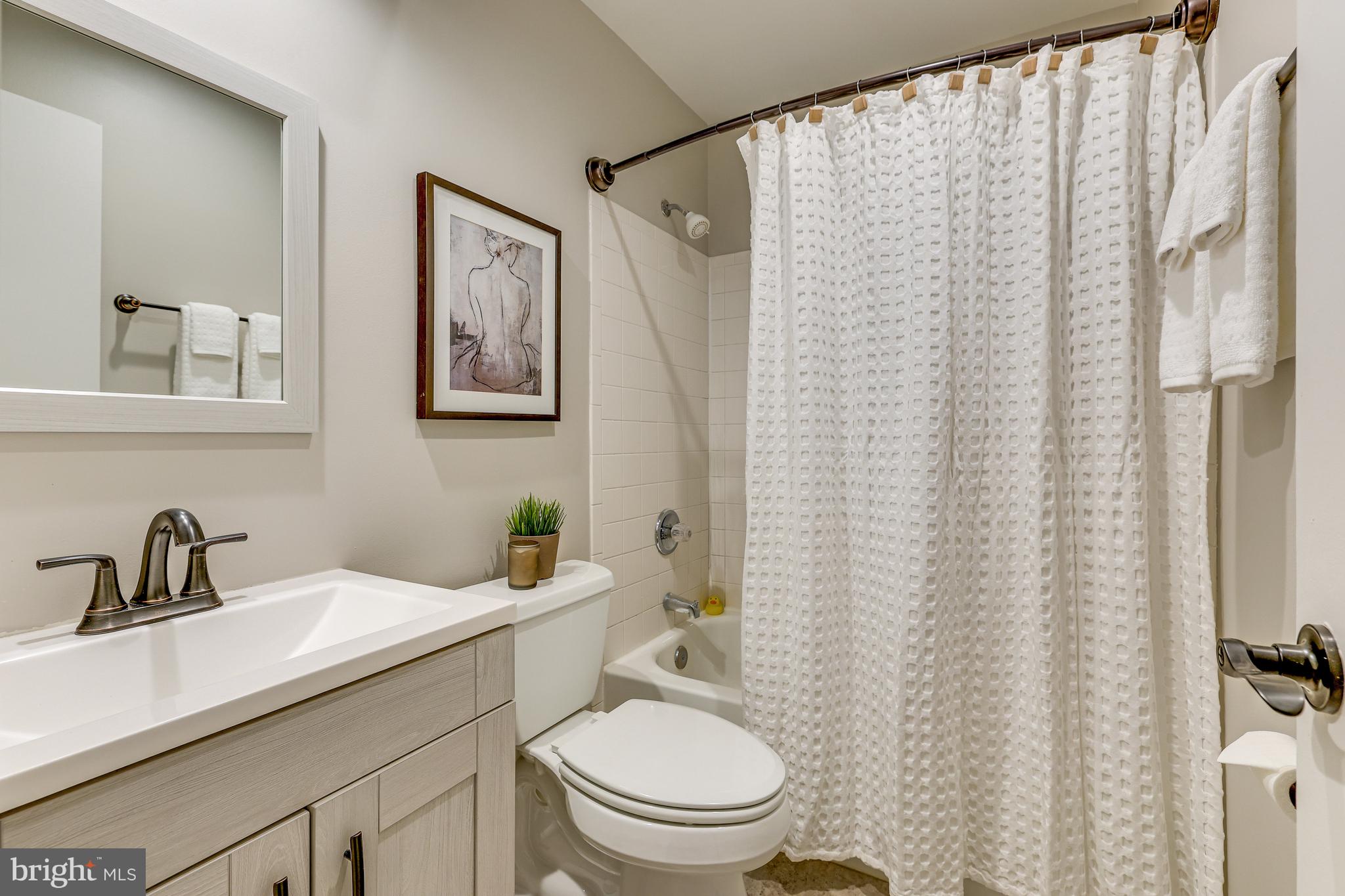 11010 Thrush Ridge Road Reston, VA 20191 - Photo 37 of 87 a bathroom with a sink a toilet and a mirror