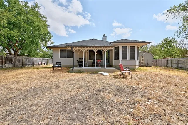 a front view of a house with a yard patio and fire pit