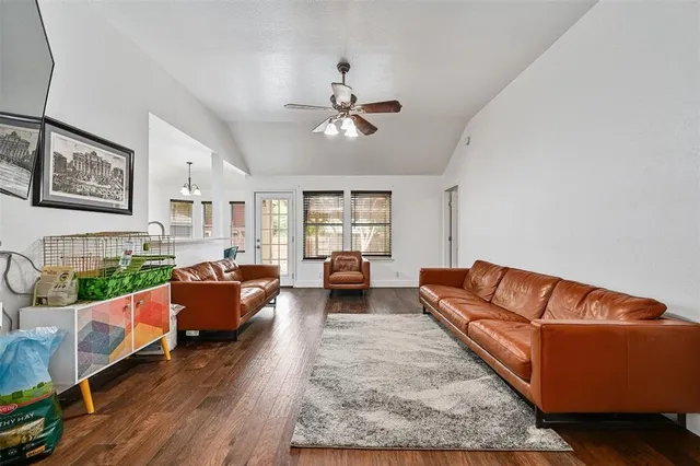 a living room with furniture ceiling fan and a rug