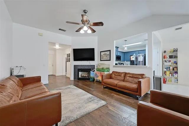 a living room with furniture a flat screen tv and a fireplace