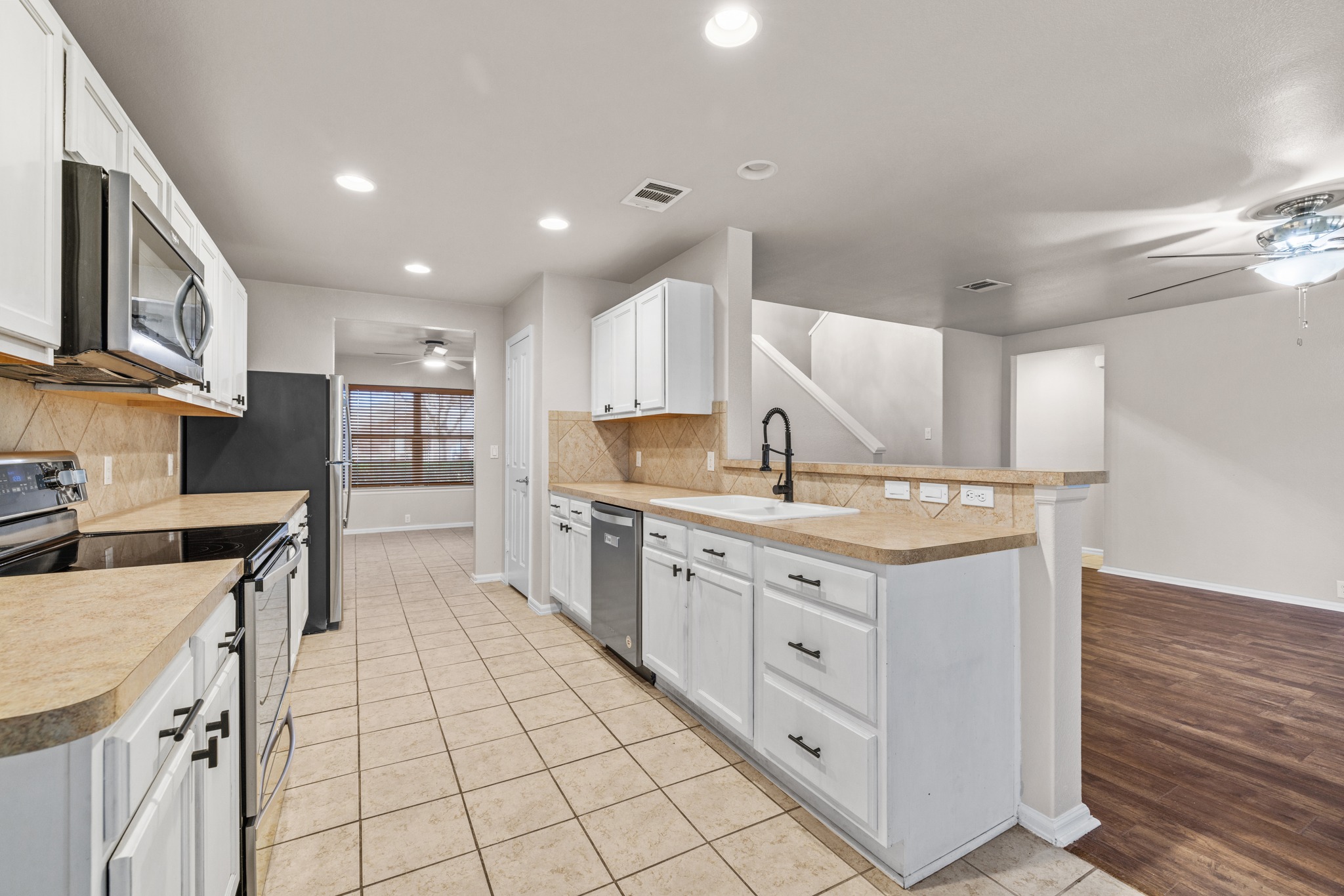 217 Inca Dove Lane Leander, TX 78641 - Photo 11 of 40 a kitchen with stainless steel appliances granite countertop a stove and a sink