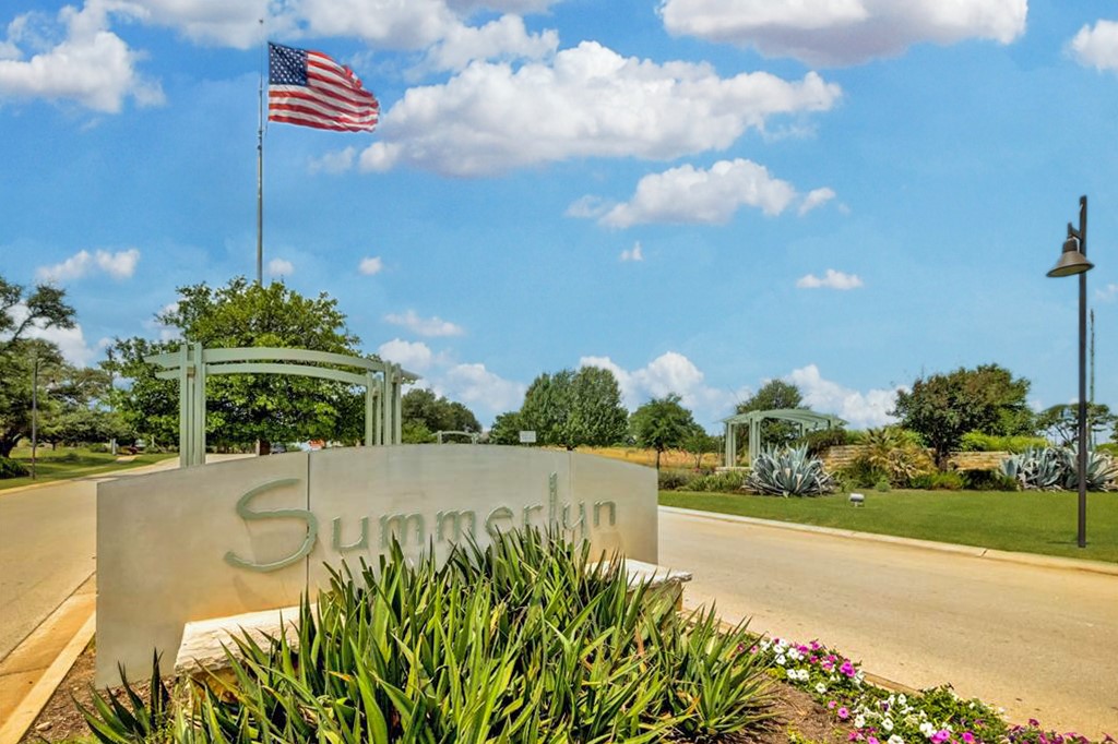 217 Inca Dove Lane Leander, TX 78641 - Photo 32 of 40 a street view with flower plants and wooden fence