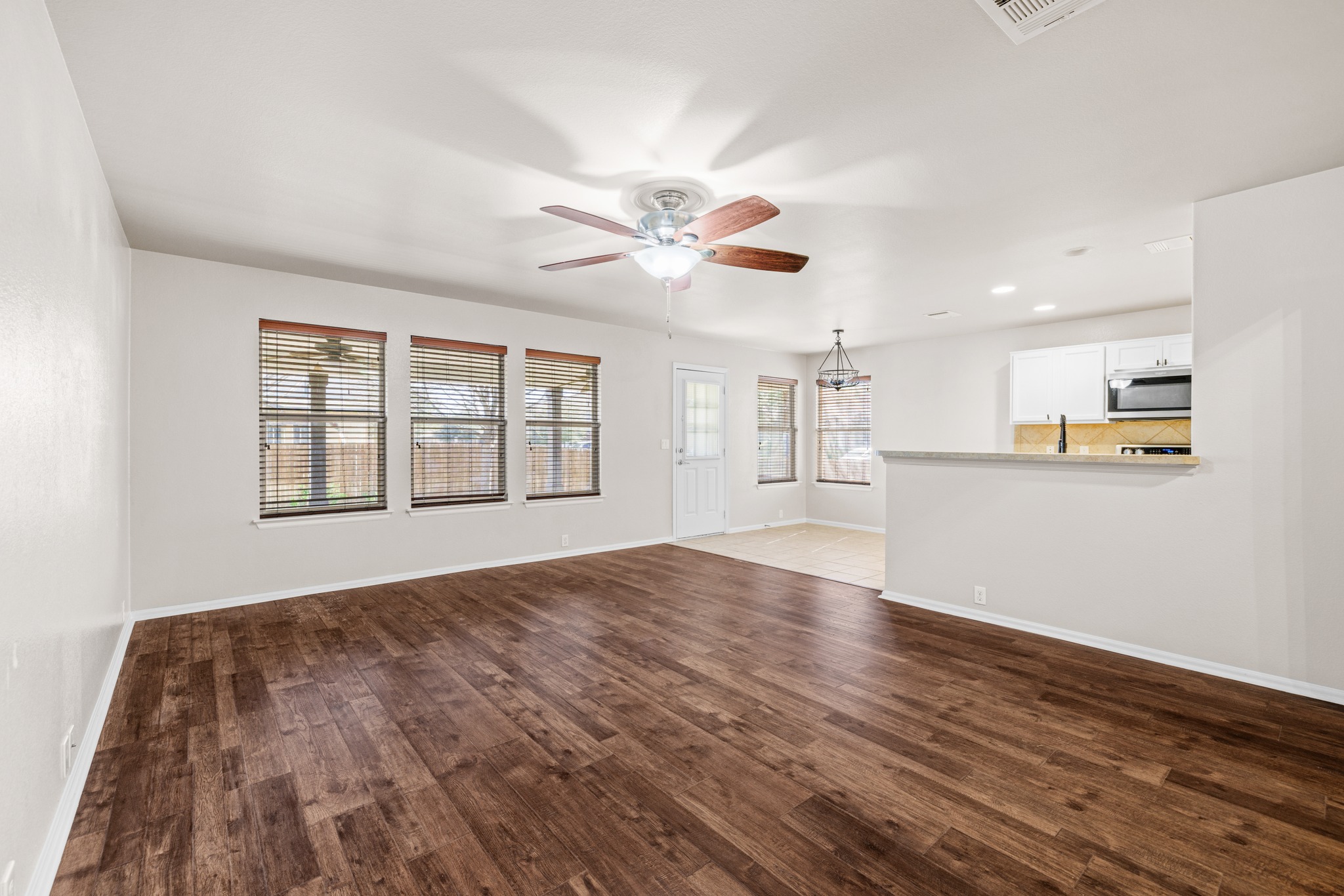 217 Inca Dove Lane Leander, TX 78641 - Photo 6 of 40 a view of an empty room with window and wooden floor