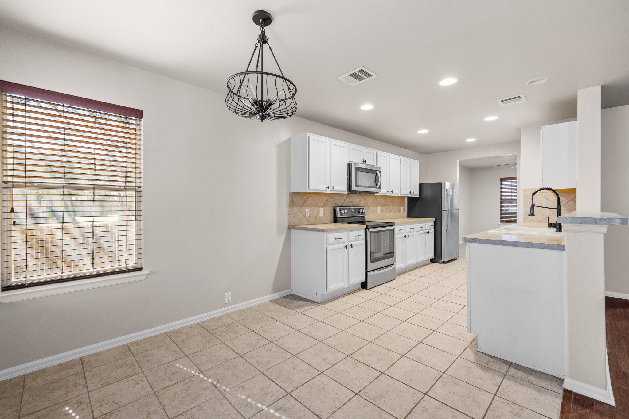 217 Inca Dove Lane Leander, TX 78641 - Photo 9 of 40 a kitchen with a stove a sink and a refrigerator