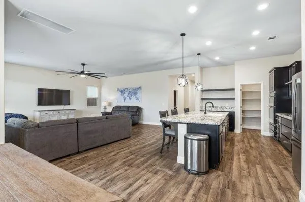 a living room with furniture and a flat screen tv