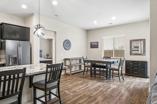 a view of a a dining room with furniture window and wooden floor