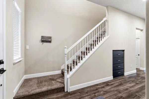 a view of entryway with stairs and wooden floor