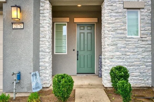 a front view of a house with a garden