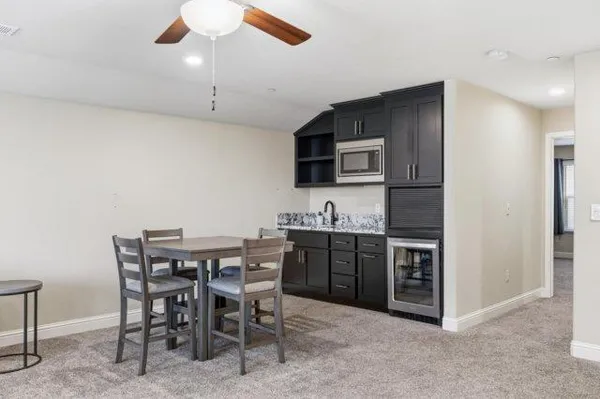 a view of kitchen with sink stainless steel appliances and dining table