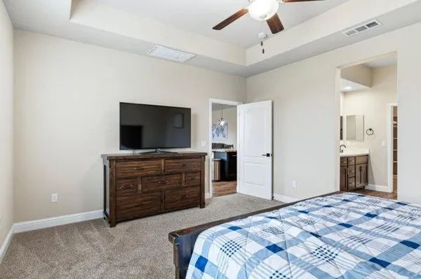 a bedroom with a bed and a flat screen tv