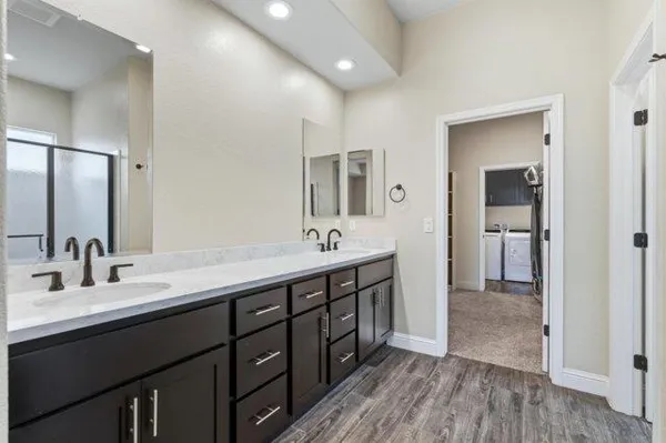 a bathroom with a double vanity sink and a mirror