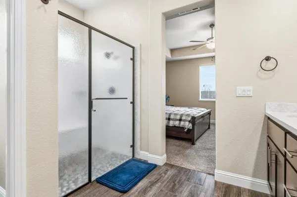 a walk in closet with view of bedroom