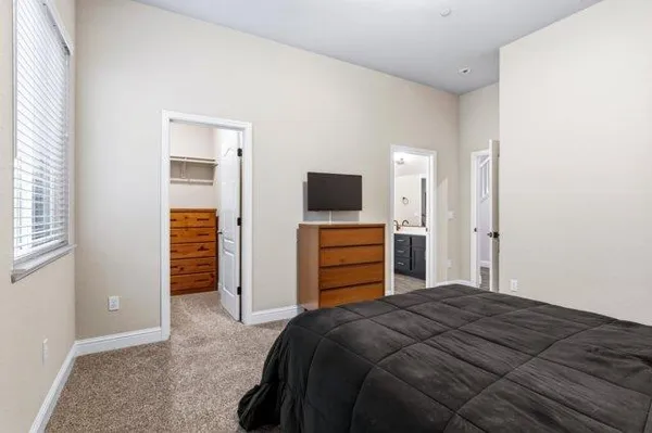 a bedroom with a bed and window