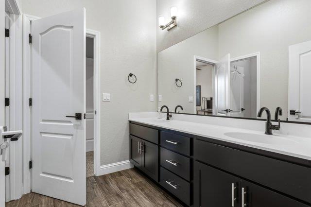 2178 Al Fonseca Lane Manteca, CA 95337 - Photo 31 of 46 a bathroom with a double vanity sink a mirror and a shower