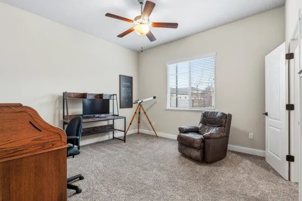 a spacious bedroom with a bed and a chandelier