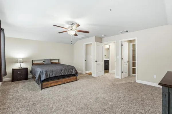 a bathroom with a toilet a sink a mirror and a shower