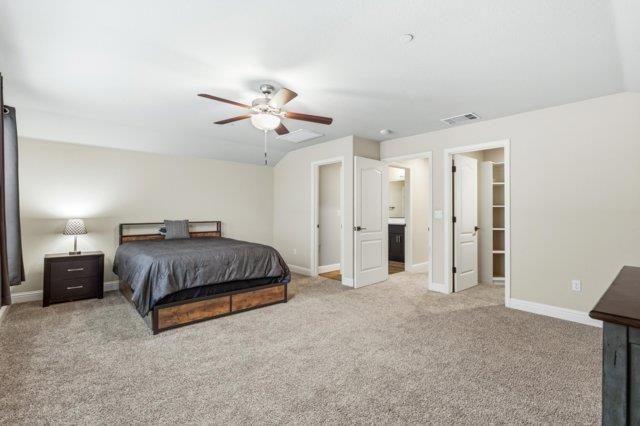2178 Al Fonseca Lane Manteca, CA 95337 - Photo 34 of 46 a spacious bedroom with a bed and a chandelier