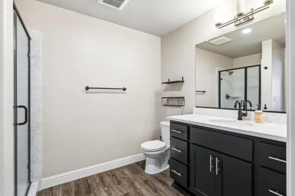 a bedroom with a bed and a ceiling fan