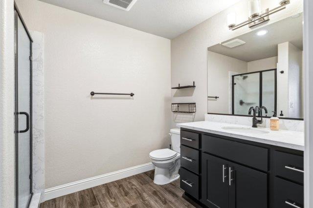 2178 Al Fonseca Lane Manteca, CA 95337 - Photo 35 of 46 a bathroom with a toilet a sink a mirror and a shower