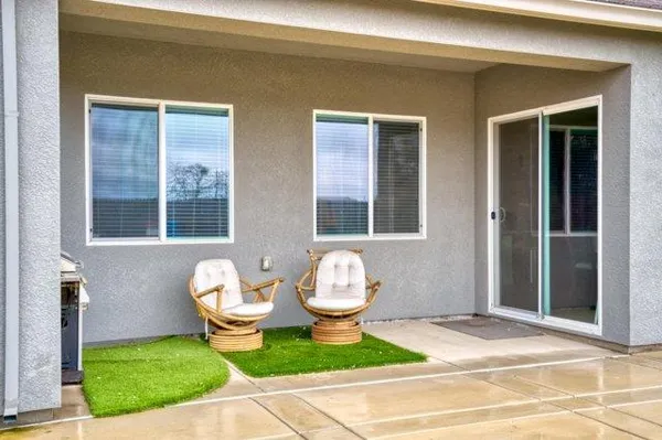 a swimming pool with outdoor seating and yard