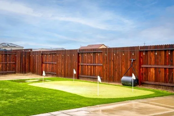a living room with patio furniture and a fireplace