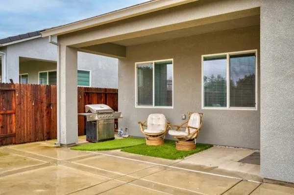 a view of swimming pool with outdoor seating and yard in the back