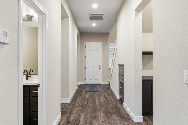 2178 Al Fonseca Lane Manteca, CA 95337 - Photo 6 of 46 a view of a hallway with wooden floor and staircase