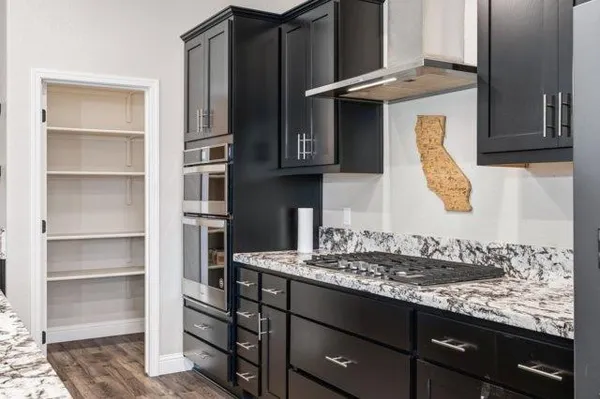 a kitchen with a sink a stove and cabinets