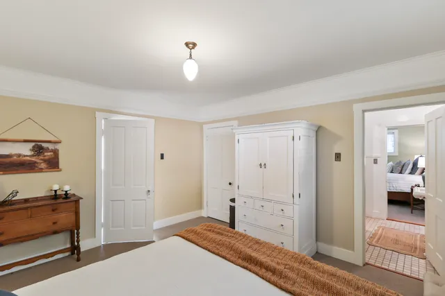 a bedroom with a bed and a table in it