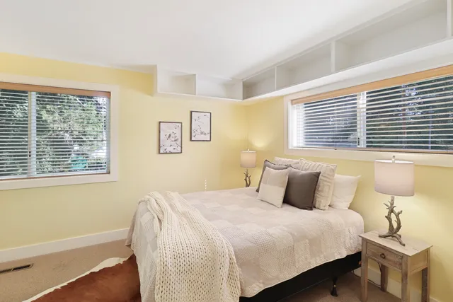 a bedroom with a large bed and a window