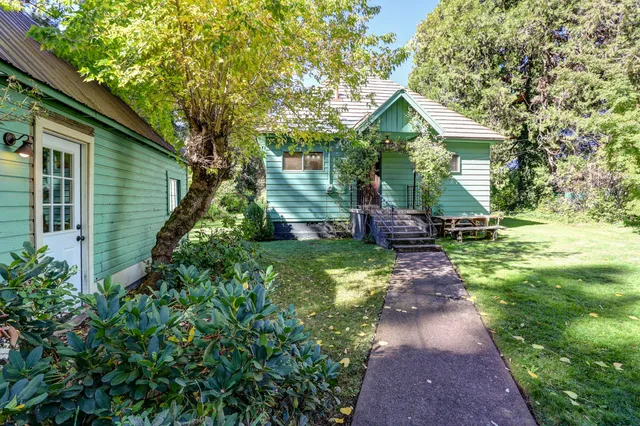 a backyard of a house with yard and outdoor seating