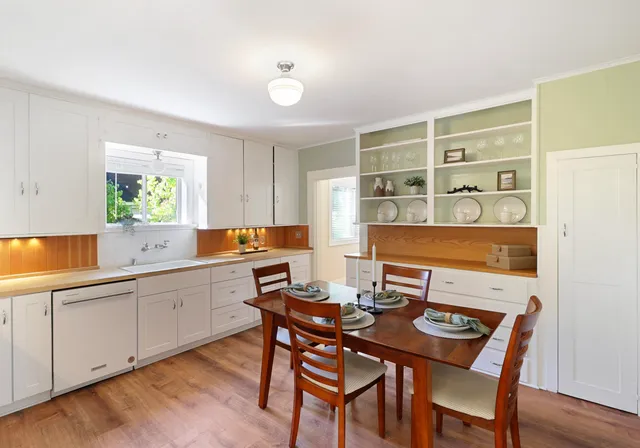 a view of a dining room with furniture and window