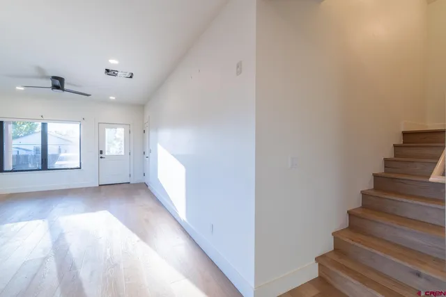 a view of an entryway with wooden floor