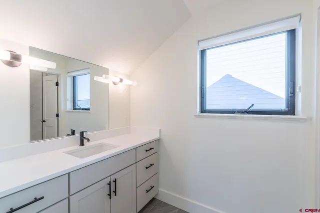 a bathroom with a sink and mirror