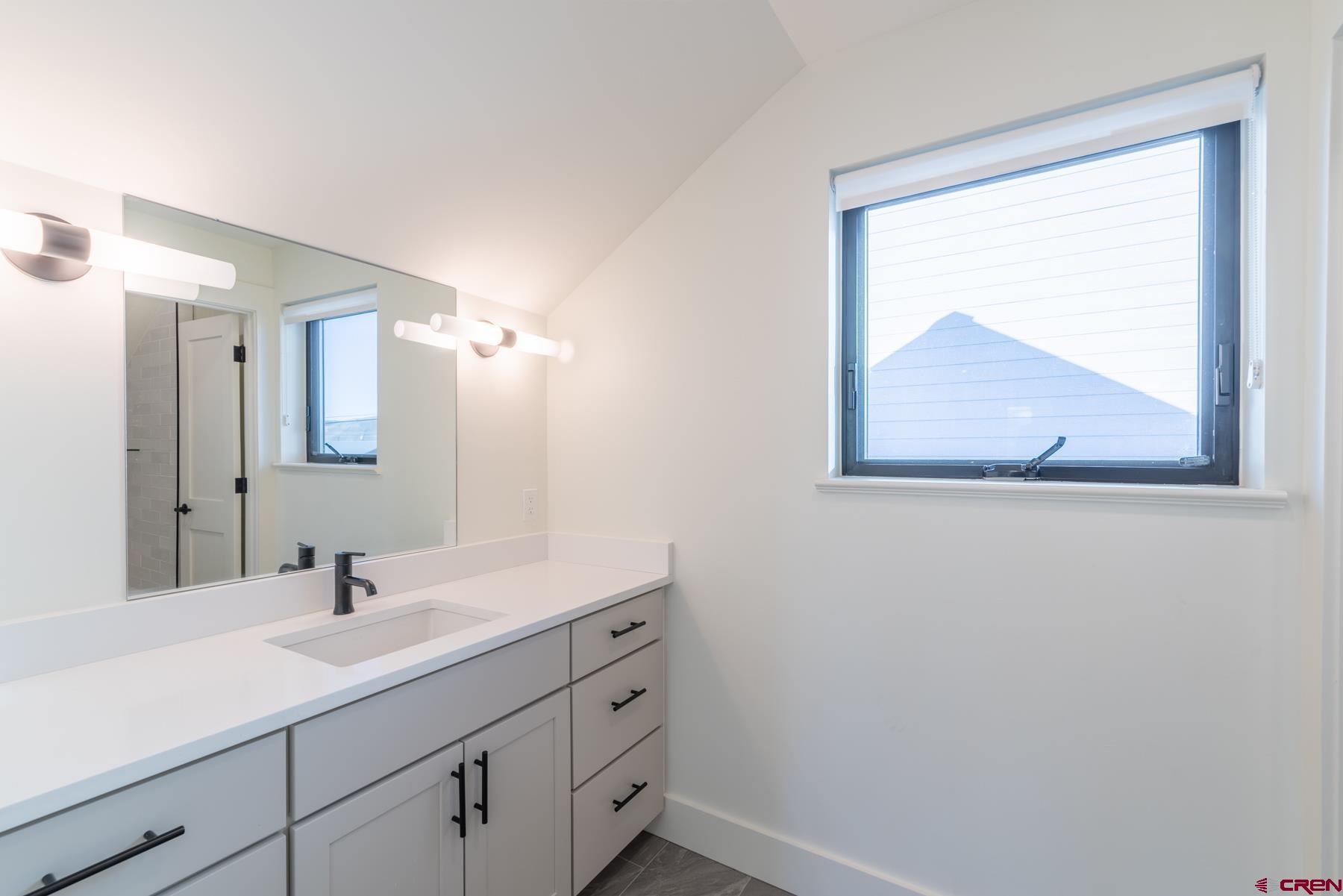 417 South Boulevard Street, Unit B Gunnison, CO 81230 - Photo 14 of 26 a bathroom with a sink and mirror