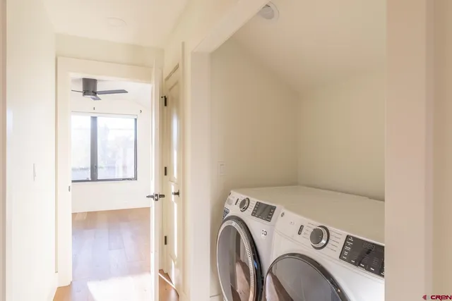 a view of washer and dryer with kitchen in the background