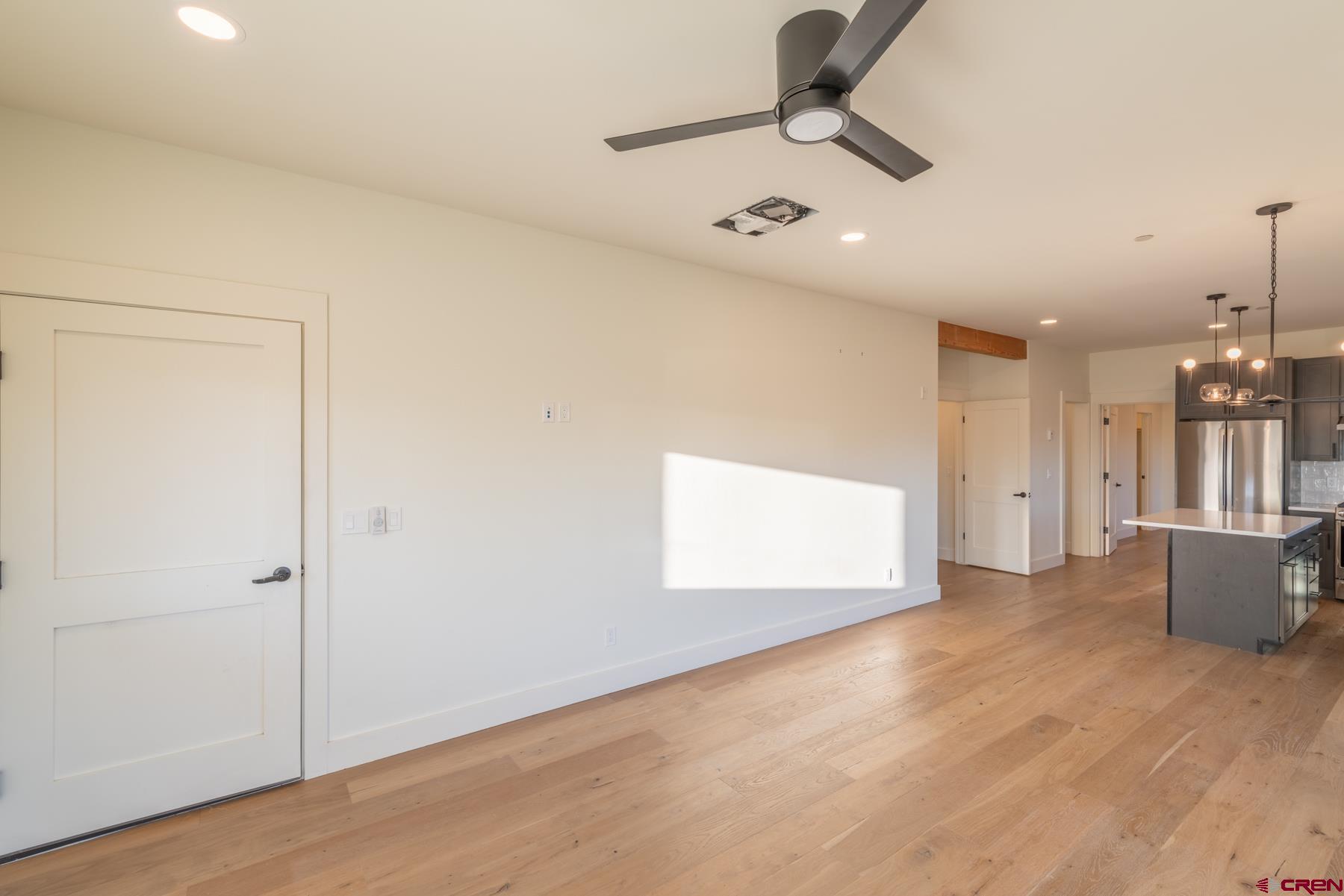 417 South Boulevard Street, Unit B Gunnison, CO 81230 - Photo 21 of 26 wooden floor in an empty room with a window