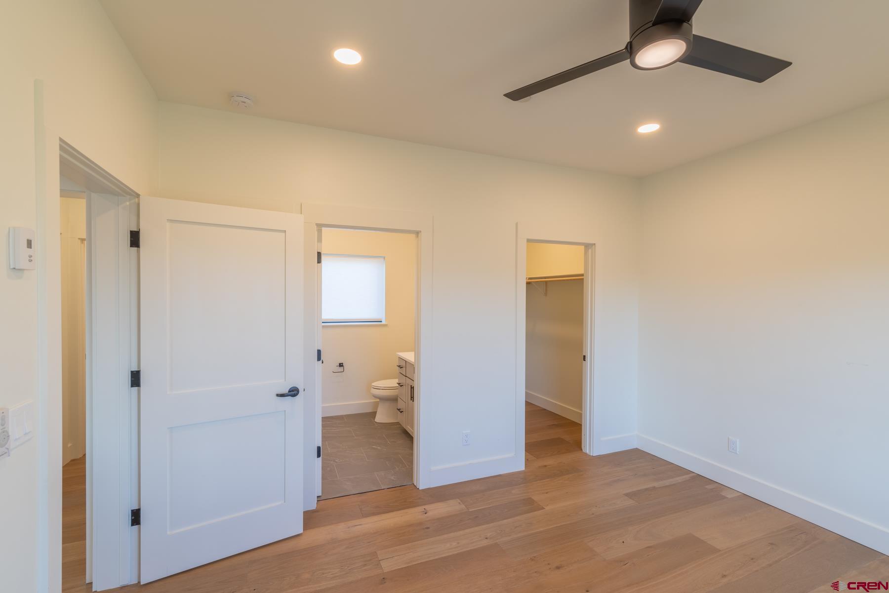 417 South Boulevard Street, Unit B Gunnison, CO 81230 - Photo 7 of 26 a view of a livingroom with a chandelier fan and wooden floor