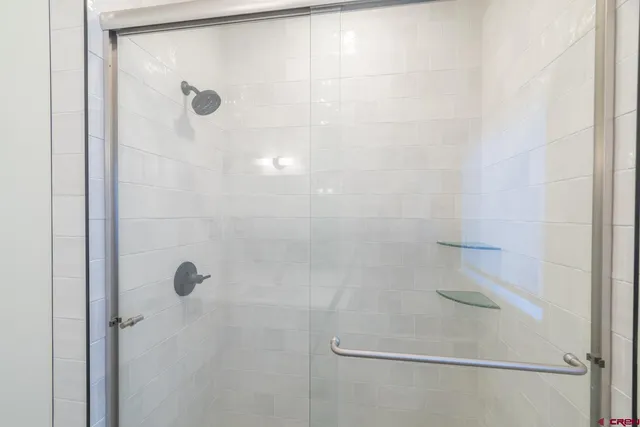 a bathroom with a glass shower door