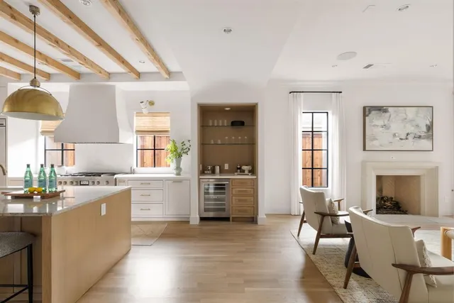 a kitchen with a refrigerator and a stove top oven