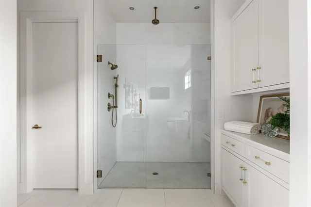 a bathroom with a shower and a sink