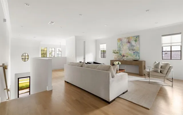a living room with furniture and view of kitchen