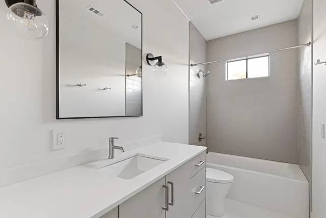 a view of a patio with table and chairs potted plants and a wooden fence